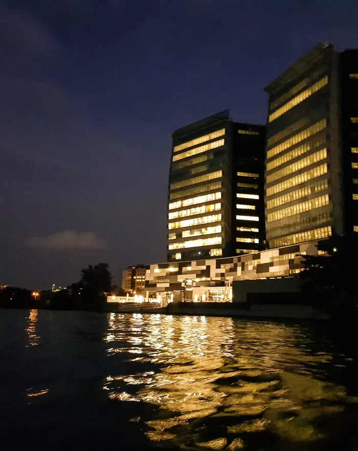 A corporate office tower lit at dusk on the Lagos waterfront.