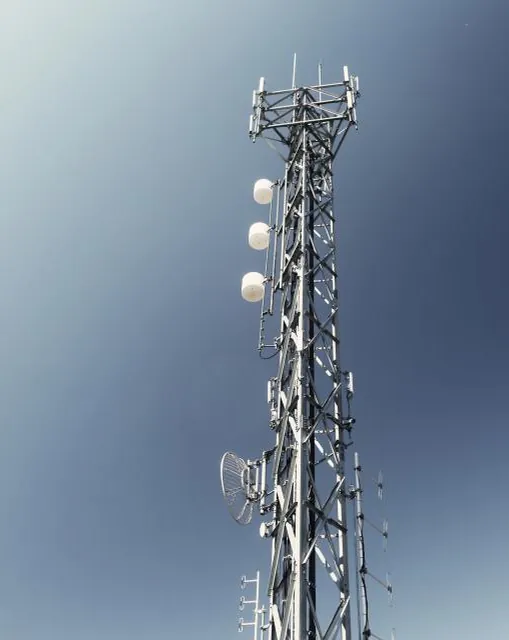A telecommunications mast carrying antennas and microwave dishes.